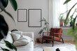 © Roman - Frame mockups on a white wall in scandinavian natural style living room, brown leather armchair, white sofa, potted plants. Two blank vertical din A posters in black frames, light room interior design