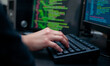 © Photo Builder - a coder’s hands typing rapidly on a mechanical keyboard with code scrolling on the screen in the background