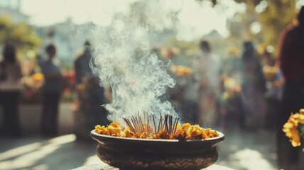 Wide-angle view of incense burning during a Day of the Dead ceremony, people softly blurred in the background, warm natural light enhancing the spiritual and reflective ambiance. Day of the Dead