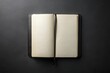 © yuwaree - Black moleskine notebook isolated on dark background from high angle view