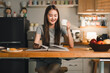 © PRIME STOCK LAB - young woman enjoys cozy moment at home, sipping coffee while reading book in modern kitchen. warm ambiance and inviting decor create relaxing atmosphere