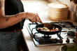 © Malambo/peopleimages.com - Hands, woman and cooking with frying pan in kitchen on stove with food and vegetables. Closeup, female person and meal prep at home with diet, nutrition and ingredients or recipe with healthy flavor