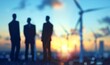 © Q STOCK - Investors and technician who are out of focus in the foreground are standing in talks about wind turbine power generation, Wind turbine farm is an alternative electricity source for business esg ideas