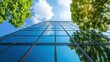 © zeitgenstd - This is a sustainable green building. An eco-friendly building. A sustainable glass office building. The building has a modern design, and it is tall and has a view of the sky.