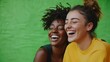 © Justlight - A pair of friends laughing together sharing a moment of camaraderie in front of a natural backdrop.