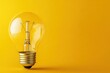 © is - Bright Light Bulb on Yellow Background