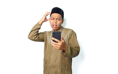 confused asian muslim man holding mobile phone with touching his head isolated on white background