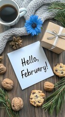 A white card welcomes February beside cookies and a coffee cup on a wooden table, surrounded by pine branches for a cozy winter feel