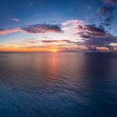 Wall Mural - aerial panoramic view of sunset over ocean colorful sky clouds water beautiful serene scene wide angle seascape drone view majestic stunning nature background best sea sky sunrise inspire views