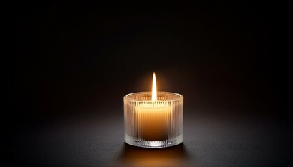 Wall Mural - candle light glowing in dark background with copy space