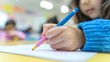 © Tadeusz - Young girl coloring with crayons, focused on her artwork in a bright classroom.