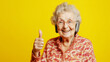 © Pixcellence - Smiling Elderly Woman with Headphones Gives Thumbs Up - Positive Vibes