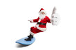 © Ljupco Smokovski - Santa claus riding a surfboard and gesturing thumbs up