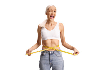 Excited young woman measuring waste