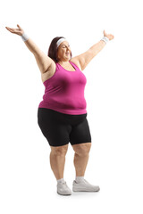 Wall Mural - Overweight young woman in sportswear raising arms