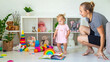 © Anna - little girl playing with toys. Selective focus