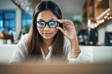 Poster - Business, laptop and woman in cafe, glasses and research for web design, clear vision and startup. Happy person, freelancer and entrepreneur with computer, eyewear and online reading in coffee shop