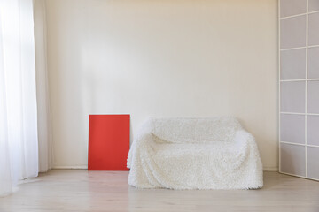 Poster - White sofa in the interior of a white room with a window