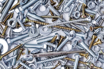 Mixed screws and nails. Industrial background. Home improvement.bolts and nuts.Close-up of various screws. Use for background, top view.