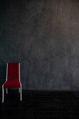 Wall Mural - One red chair in the interior of an empty gray room