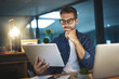 © peopleimages.com - Thinking, night and business man on tablet for research project, online website and internet. Professional, office and person on digital tech working late for planning, solution and problem solving