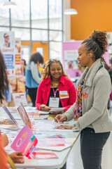 Young people attending a college fair and choosing their future career