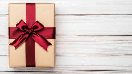 Elegant gift box with red ribbon on wooden background