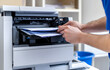 © Prasanth - Technician hand open cover photocopier or photocopy to fix repair copier problem paper jam and replace toner cartridges for scanning fax or copy document in office workplace concept of service support