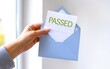 © Jason - Hand holding passed envelope. Test result success