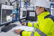 © reewungjunerr - Inside the large Industry Factory Female Computer Engineer Works on Personal Computer She coding program for control machine,Thailand people work on fours monitors,Programmer working with serious