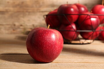 Fresh ripe red apples on wooden table