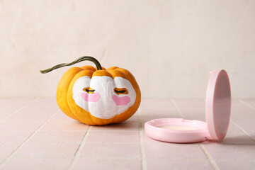 Wall Mural - Pumpkin with clay mask and powder on pink tile table against grunge background