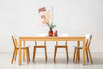 Poster - Table with eucalyptus branches in vase and candles in stylish dining room