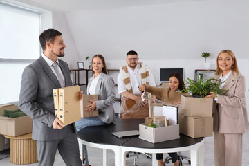 Wall Mural - Group of business people packing things in office on moving day