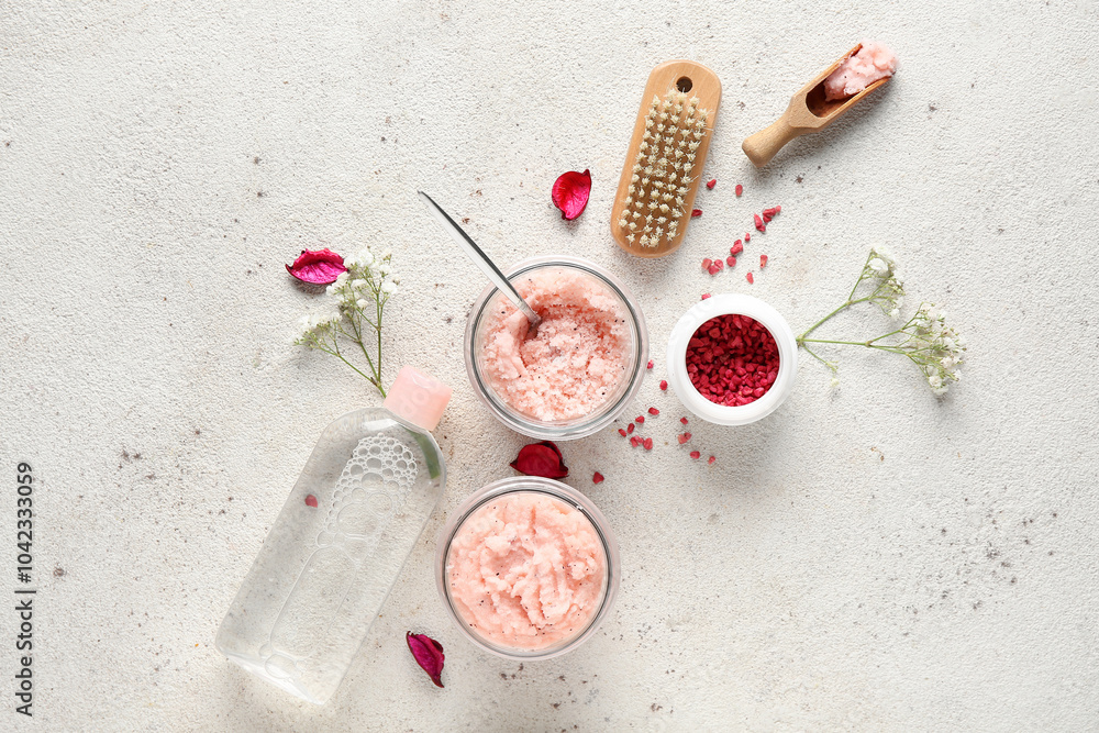 Composition with natural body scrubs, ingredients and massage brush on light background