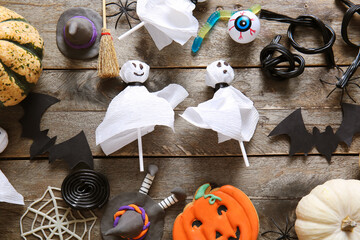 Sticker - Composition with tasty lollipops and Halloween decor on wooden background