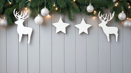 A wooden wall decorated with white Christmas ornaments, featuring deer silhouettes and branches, creates a warm holiday atmosphere