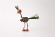 © Elena - A handmade bird crafted from pine cones and twigs, on a white background, funny character made by child from nature materials from forest, autumn craft for kids,