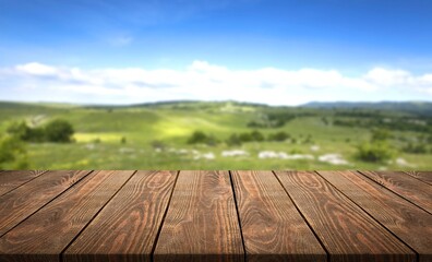 Wall Mural - the empty wooden table top with background of farmland