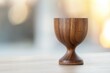 © Space Priest - A wooden cup sits on a wooden table