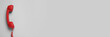 © New Africa - Red corded telephone handset on grey background, top view. Banner design with space for text
