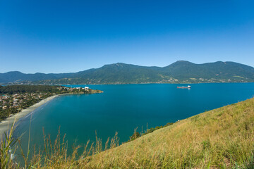 Beautiful panoramic view of Ilhabela island and coast of Sao Sebastiao, tropical island on the Brazilian sea coast during a sunny day of vacation and sightseeing.