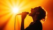 © LifeMedia - The artist passionately sings into a microphone, captured in a powerful photograph with stunning backlit orange lighting, evoking a sense of energy and emotion.