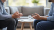 © whoopwhoops - therapist and patient seated in comfortable sofa, engaged in a conversation. no face show on image.