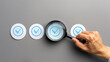 © Mutshino_Artwork - A hand using a magnifying glass to closely inspect a series of blue checkmark icons on paper, symbolizing quality control, validation, and detailed scrutiny