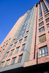 A tall brick building with a blue sky in the background