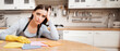 © Prostock-studio - Exhausted Housewife Concept. Tired woman sitting at desk in kitchen with rags on the table, free space