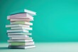 © wiraphat - Colorful Stack of Books on a Turquoise Background
