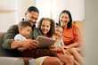 © peopleimages.com - Tablet, streaming and movie with family on sofa for love, online game and happiness together. Relax, bonding and social media with parents and children in living room at home for film, app and care