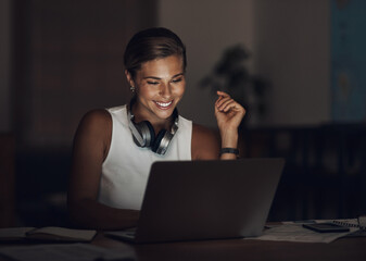 Fototapete - Night, happy woman and laptop in home for remote work, productivity and good news. Administrator, computer and smile at desk for deadline, finance management and email communication with headphones